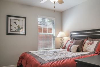 A bedroom with a bed and a window